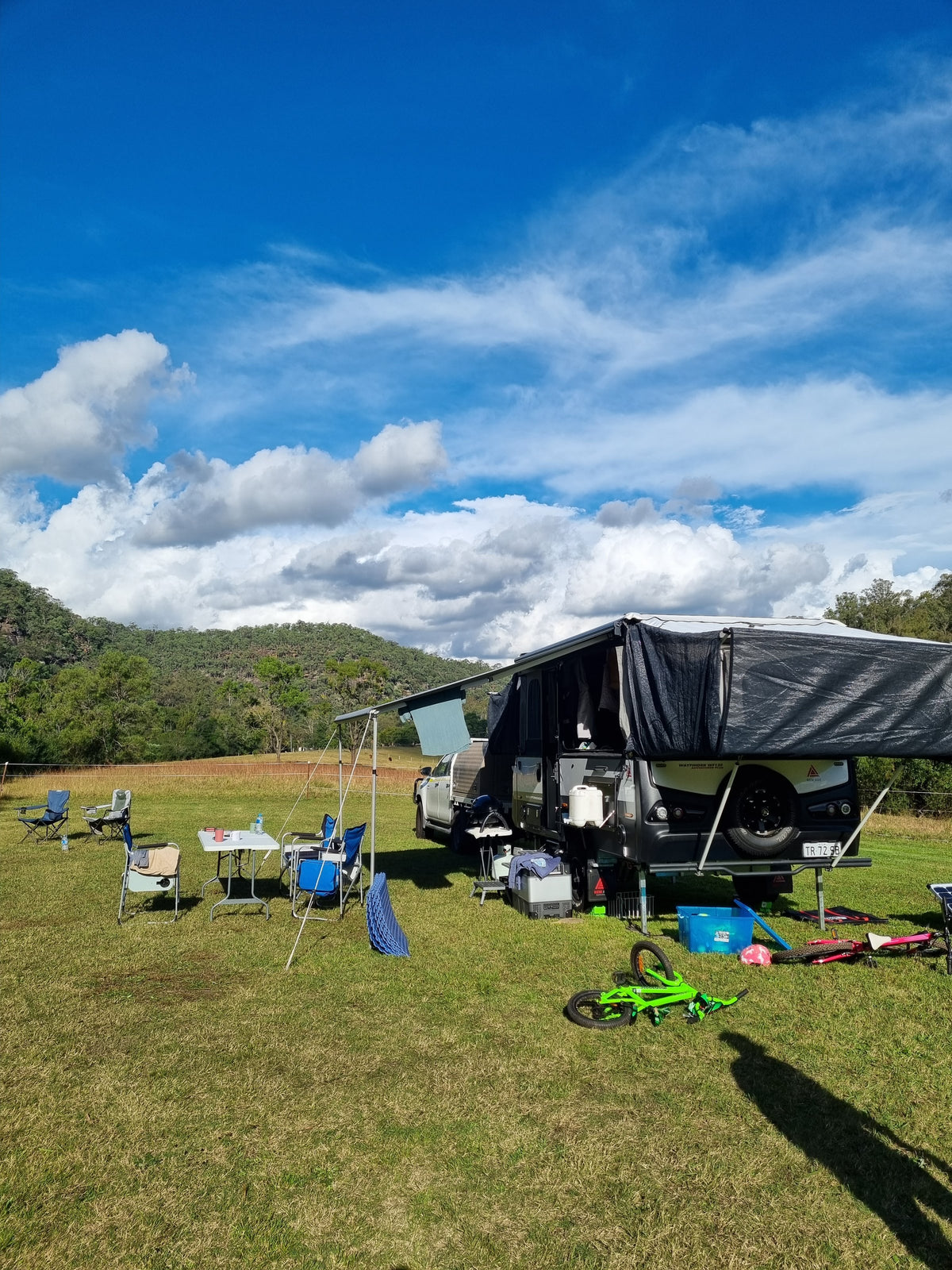 Camper trailer set up on the grass